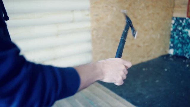 Man is going to throw axe the target