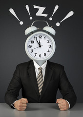 Businessman with ringing alarm clock instead of head, time limit concept