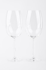 Two empty wine glasses over white. Pair of empty glasses for wine isolated on white background.