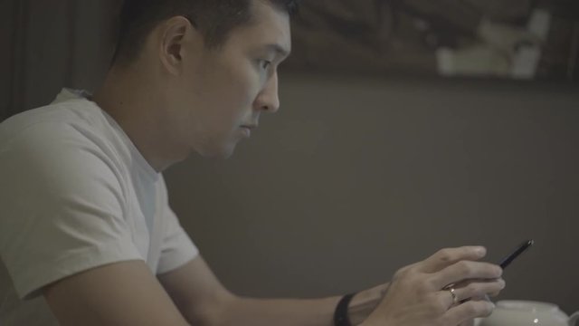 young businessmen texting message in cafe