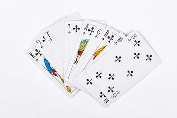 Playing cards on white background. Playing cards of a club royal flush. Playing cards showing royal flush.
