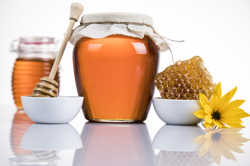 Jar of honey with honeycomb