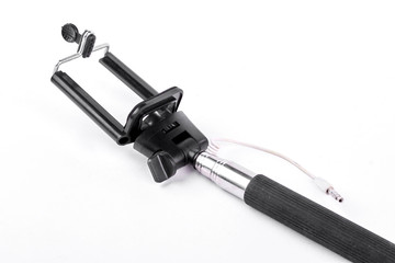 Black monopod for smartphone. New black selfie stick isolated on white background. Fashion technology to take a photo.