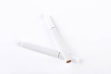 Two white cigarettes on white background. Tobacco cigarettes with filter isolated on white background.