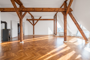 luxury apartment , empty loft room with fireplace and wooden beams