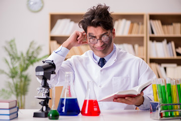 Mad crazy scientist doctor doing experiments in a laboratory