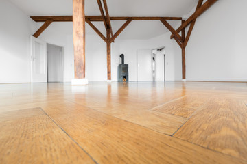 parquet floor closeup in empty penthouse room with fireplace