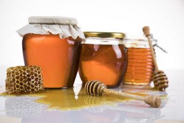 Jar full of fresh honey and honeycombs