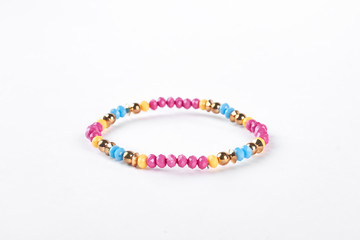 Colorful childrens bracelet for girls. Multicolored beaded kids bracelet isolated on white...
