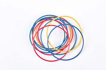 Set of colored bracelets, top view. Collection of plastic multicolored bangles on white background. Girls fashion accessories.