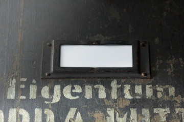 view on the front of an old wooden case for military equipment with metal fittings and a stenciled...