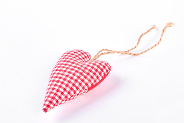 Handmade textile checkered heart. Red handmade cloth heart isolated on white background. Symbol of love and romance forever.