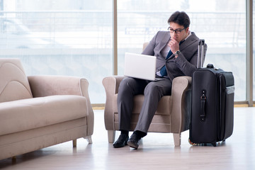 Young businessman in airport business lounge waiting for flight