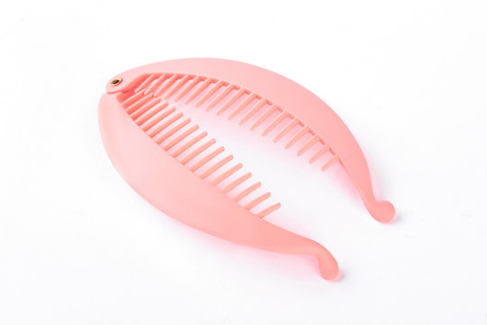 Pink hair pin on white background. Plastic hair pin with teeth isolated on white background.
