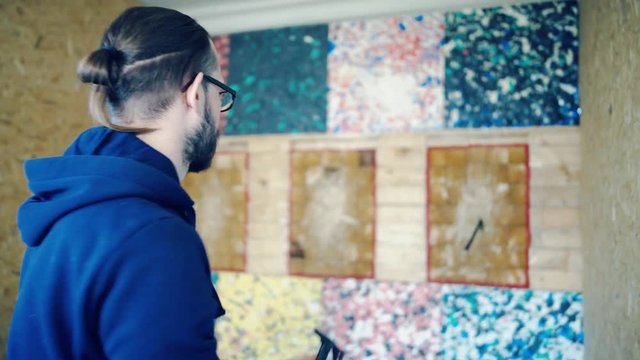 Young man throws axes at the target