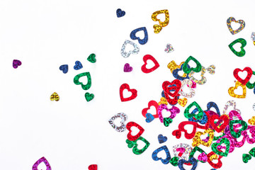 Paper hearts shiny confetti. Collection of multicolored heart shaped paper confetti on white background. Birthday or wedding decoration.