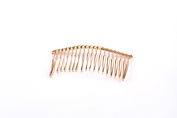 Metal hair comb on white background. Gold hair comb isolated on white background. Comb to create unique look.