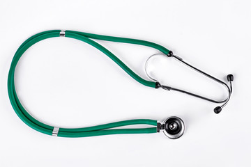Green medical stethoscope, white background. Medical equipment isolated on white background. Health examination concept.