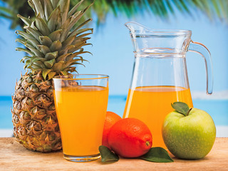 variety of fruit and juice on a wooden table in the garden