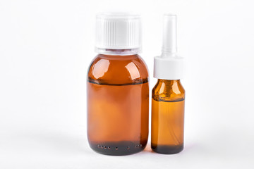 Medication to treat running nose. Two brown glass bottles with medicine for cold treatment. Cold and treatment concept.
