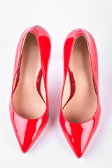 Ladies red heels, top view. Woman classic red shoes on high heels isolated on white background. Female elegant shoes on sale.