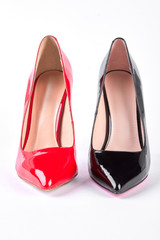 Red and black heels on white. Female red and black high heel shoes isolated on white background.