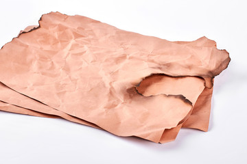 Vintage paper with burned edge. Burnt piece of ancient paper isolated on white background. Photo of burned torn sheet of old paper.