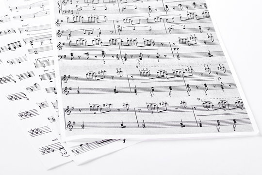 Sheets with musical notes. Pages with musical notes and keys, isolated on white background.