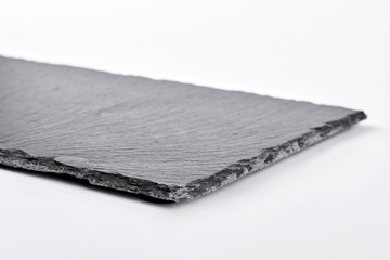 Square slate tray, white background. Dark gray slate plate over white background.