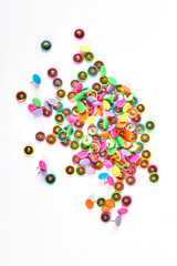 Many colorful push pins, white background. Isolated pile of colorful push pins. Heap of multicolored push pins on white background, top view.