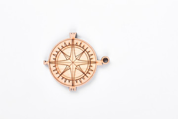 Cardboard compass on white background. Handmade figure of compass made from wood isoalted on white backgrounnd.