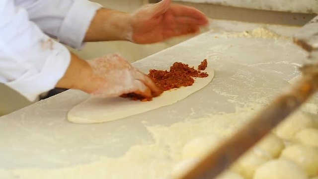 Closeup of male hands of professional cooker making delicious traditional Turkish cakes. Real time full hd video footage.