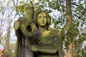 The stone Girl on Tomb from the autumn old Prague Cemetery, Czech Republic