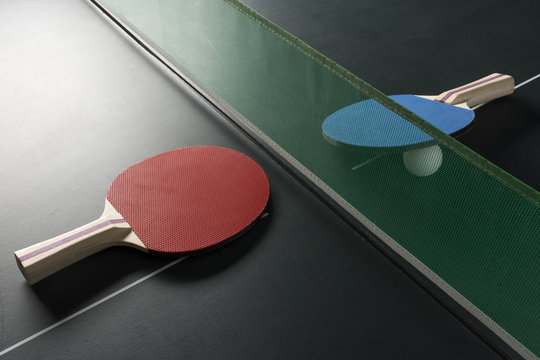 Ping Pong Paddles on Table with Net, Harsh Light