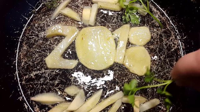 fry potatoes in a frying pan in the form of number 2018