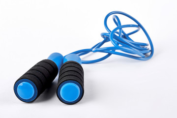 Blue skipping rope on white background. Modern jump rope isolated on white background. Equipment for workouts in gym.