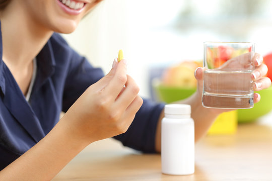 Woman Hand Holding Omega Vitamin 3 Pill