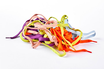 Heap of multicolored shoe laces. Pile of colorful strings for sport shoes isolated on white background.