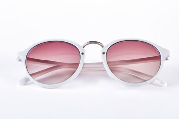 Round sunglasses with white rim. Fashion sunglasses with red glass and white plastic rim isolated...
