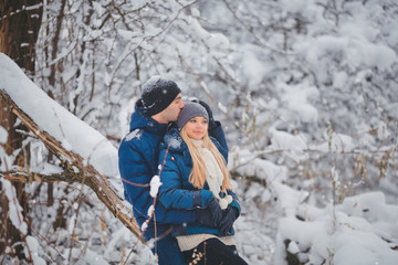 Fototapeta na wymiar Happy Couple Having Fun and Embracing Outdoors in Snow Park. Winter Vacation