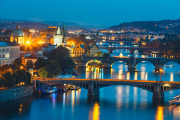 View of bridges with historic Charles Bridge and Vltava river at night in Prague, Czech Republic