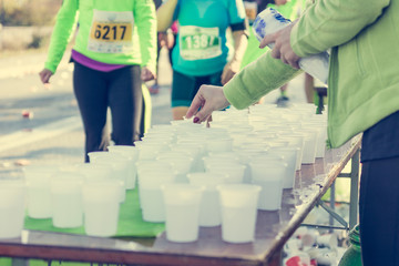 Volunteer preparing and distrubuting water to competitors.
