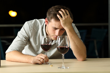 Sad man complaining after break up in a bar