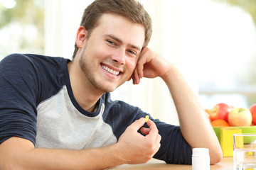 Man holding omega 3 vitamin pill