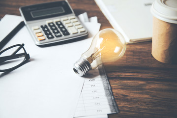 idea or light bulb and calculator on document