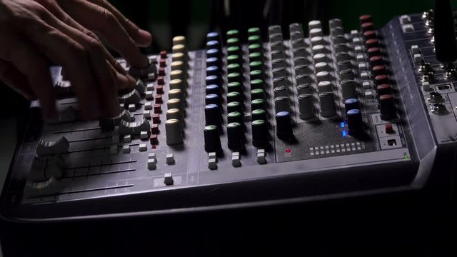 Adjusting Knobs and Levers on Mixing Console, Close up Hands