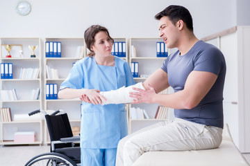 Fototapeta premium Doctor and patient during check-up for injury in hospital