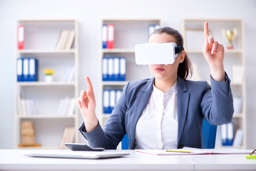 Businesswoman with virtual reality glasses in office