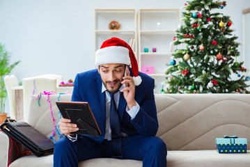 Businessman working at home during christmas