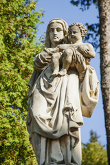 Fototapeta premium Fragment of ancient statue of the Virgin Mary with the baby Jesus Christ (Religion, faith, eternal life, God, the soul concept)